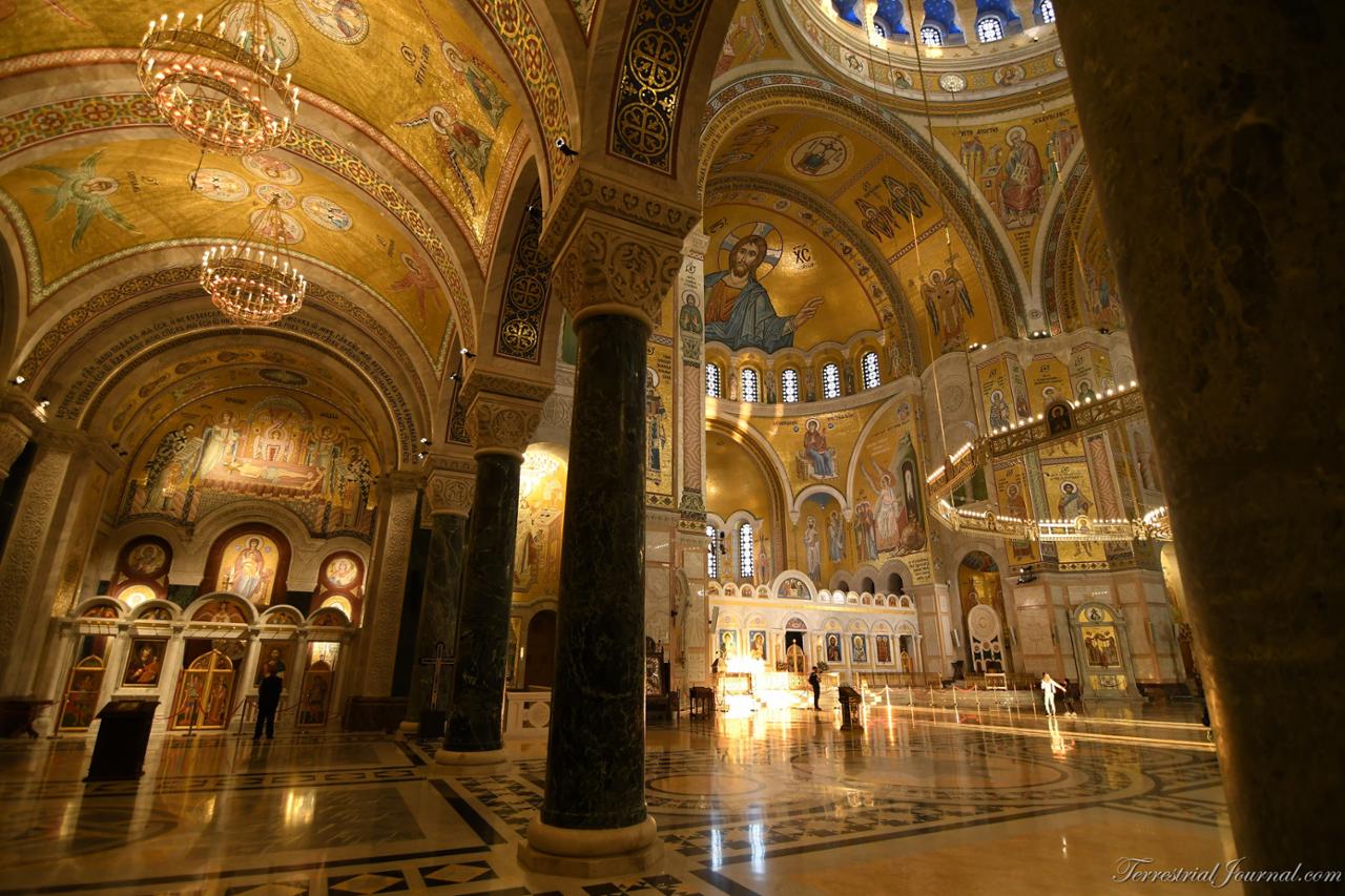 Underneath the choir gallery to the left of the main entrance